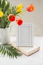Flowers vase frame placed table near wall