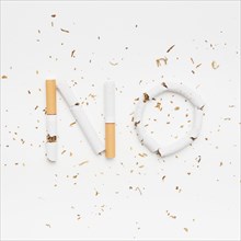 Word no made from broken cigarette with tobacco isolated white background