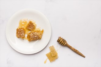 Top view honey spoon with honeycomb pieces