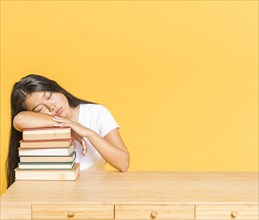 Pile books desk woman sleeping