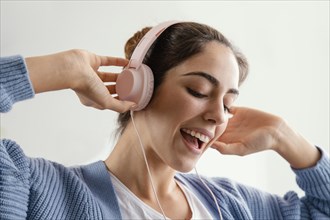 Smiley woman listening music headphones
