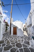 White Cycladic houses and small Greek Orthodox church