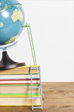 Paper ladder terrestrial global map stand ball books wooden table