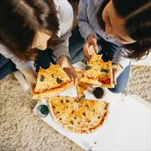Young girls having pizza floor