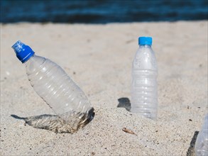 Empty plastic water bottle sand beach