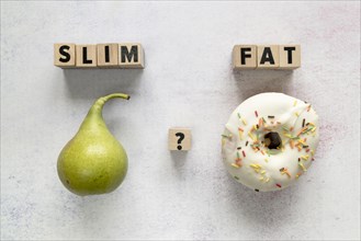 Glazed donut pear slim fat text with question mark wooden block concrete surface