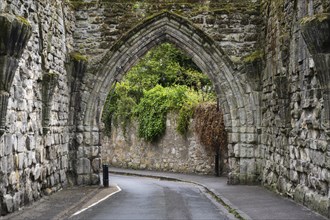 Road leading through the ruins of the 14th century gatehouse called The Pend