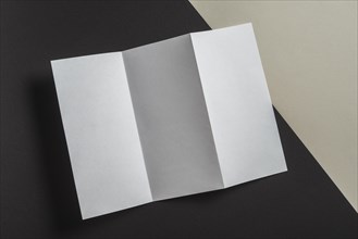 Elevated view folded white paper brochure