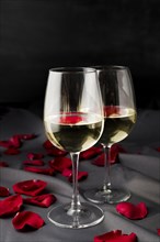 Valentine s day rose petals with wine glasses