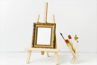 Front view minimalist frame easel brushes