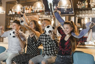 Soccer fans sitting bar celebrating victory