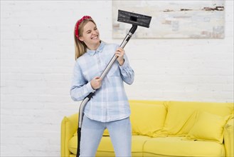 Woman cleaning playing with vacuum