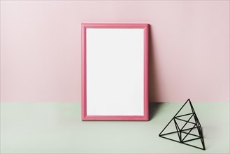 Blank white frame with pink border against pink background