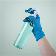 Hand with surgical glove using disinfectant