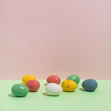 Small colorful easter eggs scattered table