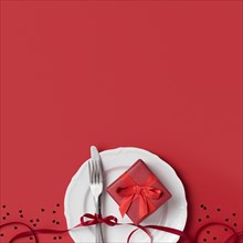 Top view valentine s day gift plate with ribbon cutlery