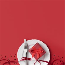 Top view valentine s day gift plate with ribbon cutlery