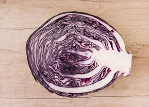 Halved red cabbage wooden background