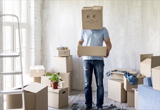 Man with box head while packing move