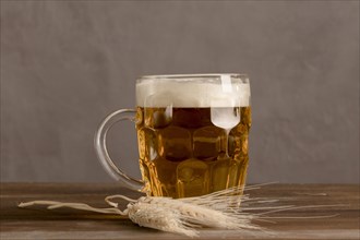 Mug light beer with wheat wooden table