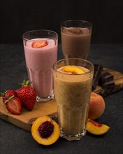 Selection three milkshake glasses with fruits chocolate