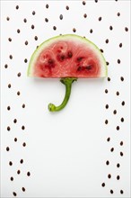 Top view watermelon umbrella with seeds white background