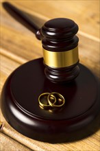Close up with judge gavel stand with wedding rings