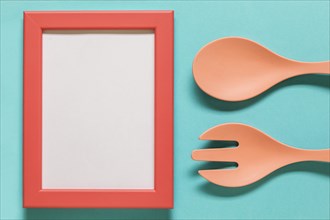 Empty frame with spoon fork blue background