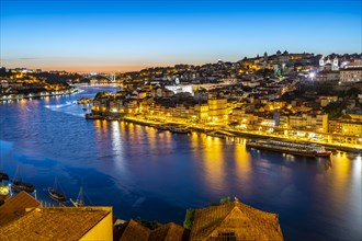 View over the river Douro to the old town of Porto at dusk
