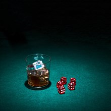 Glass whiskey red dice green casino table