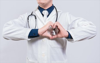Doctor making heart gesture with hands. Concept of love and medicine