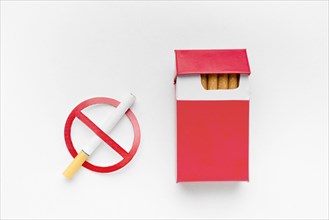 Stop smoking sign beside pack cigarettes