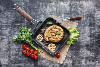 Homemade tasty spiral grilled sausage with healthy vegetable pan