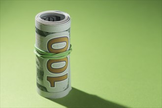 Close up rolled up banknotes green background