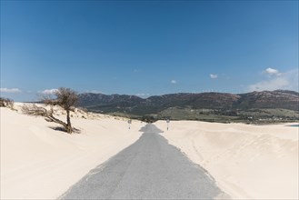 Empty road sands against mountains