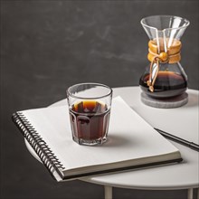 Glass coffee with notebook pen