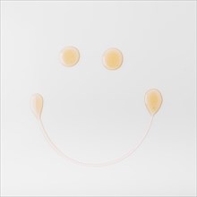 Smiley face made with honey white background