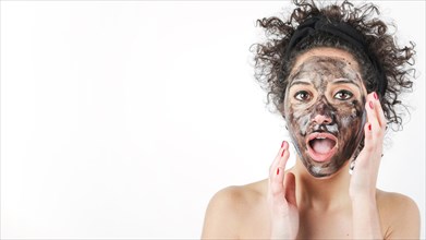 Shocked young woman with black face mask her face isolated white background