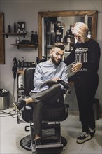 Customer showing magazine barber