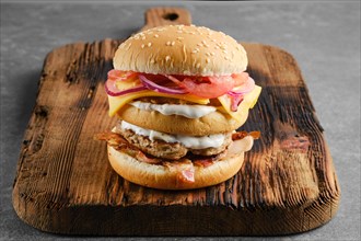 Monster double burger on wooden serving board