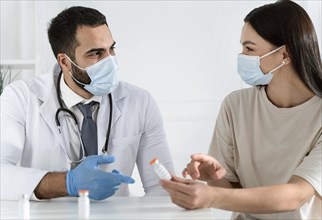 Patient talking with doctor wearing medical masks