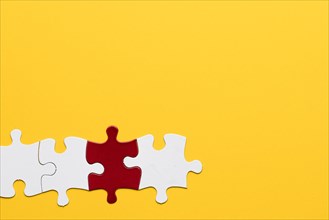 Red white puzzle piece with yellow background
