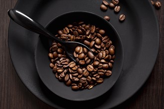 Roasted coffee beans bowl with spoon