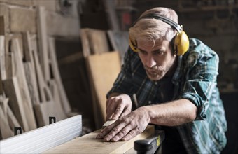 Man cutting wood planks