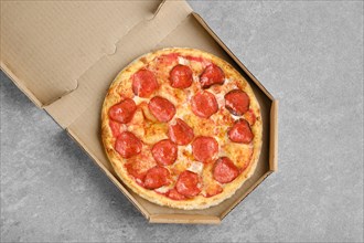 Top view of classic pepperoni pizza in cardboard box