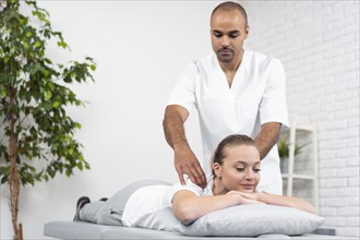 Female patient being checked by male physiotherapist