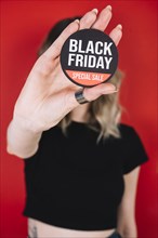 Close up woman hand with black friday sign