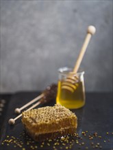 Honey comb with honey wooden dipper bee pollen