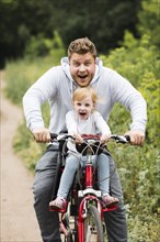Happy father daughter bike