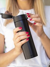 Woman holding thermos
